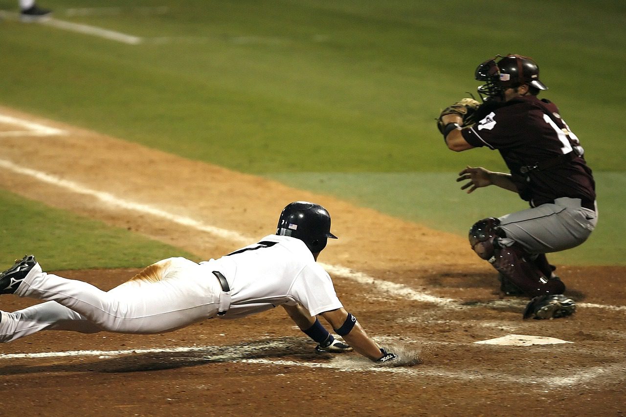 A baseball player sliding into home base