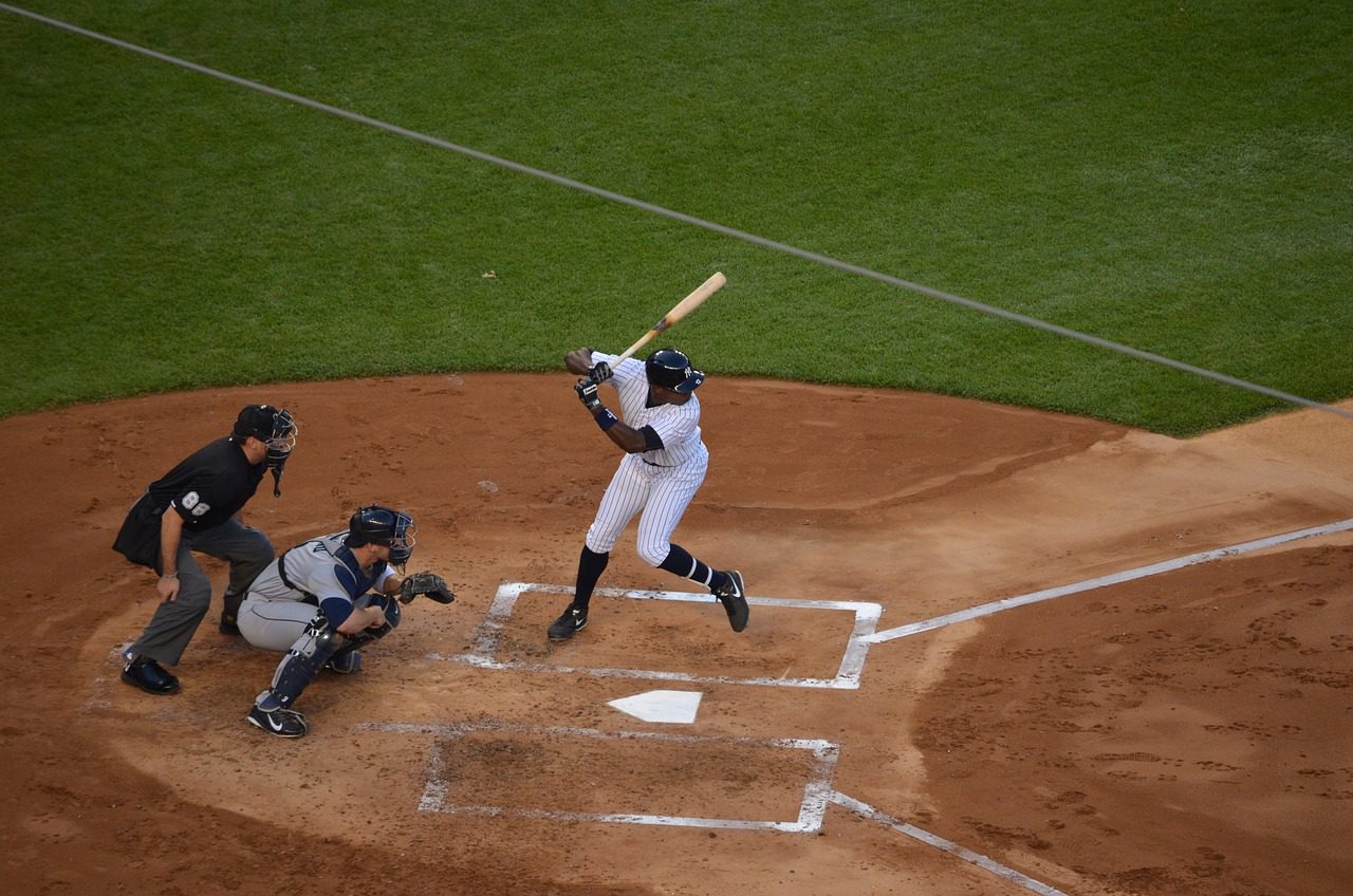 A baseball player swinging at the ball during a game.