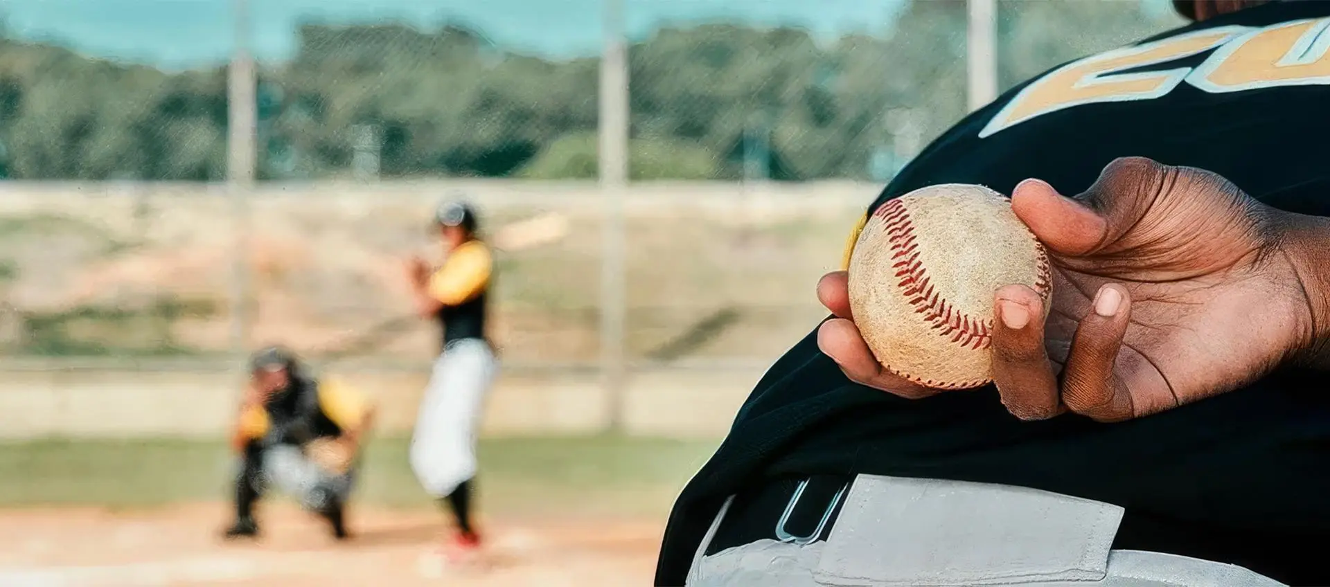 A baseball player holding a ball in his hand.